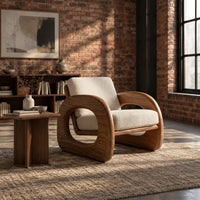 Lounge chair with thick open loop arms and sled base in an industrial loft living room with exposed brick