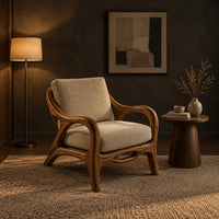 Lounge chair with sweeping arms and an oval cutout seat rail in a dark living room at golden hour
