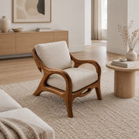 Lounge chair with sweeping arms and an oval cutout seat rail in a Scandinavian living room with white walls