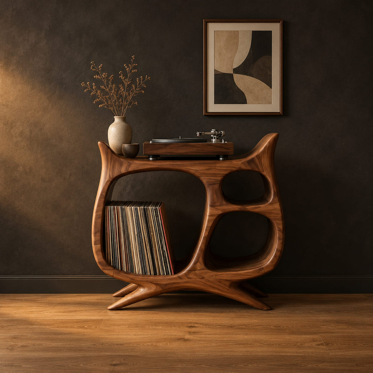 Sculptural record player stand with a large open bay, oval openings and splayed feet in a dark studio against a charcoal plaster wall