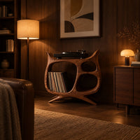 Sculptural record player stand with a large open bay, oval openings and splayed feet in an evening living room with walnut wall paneling