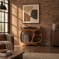 Sculptural record player stand with a large open bay, oval openings and splayed feet in an industrial loft living room with exposed brick