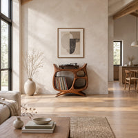 Sculptural record player stand with a large open bay, oval openings and splayed feet in a bright open plan living room