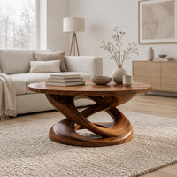 Round coffee table on a twisting interlaced loop base in a Scandinavian living room with white walls