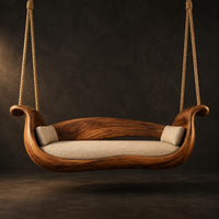 Boat shaped wooden swing with scrolled ends and a long seat cushion in a dark studio against a charcoal plaster wall