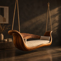 Boat shaped wooden swing with scrolled ends and a long seat cushion, three-quarter view showing the grain