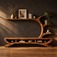 Low tv stand with a tree trunk rising into branch shelves in a dark studio against a charcoal plaster wall