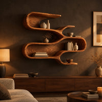 Sculptural wall shelf with three winding open tiers in a dark living room at golden hour