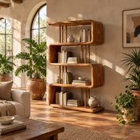 Serpentine bookshelf with looped shelves and slim vertical posts in a bright living room with arched windows and plants