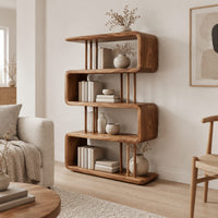 Serpentine bookshelf with looped shelves and slim vertical posts in a Scandinavian living room with white walls