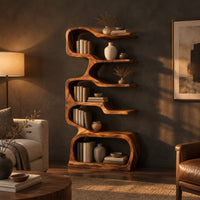 Tall serpentine bookshelf with staggered slab shelves and a loop base in a dark living room at golden hour