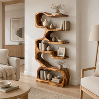 Tall serpentine bookshelf with staggered slab shelves and a loop base in a Scandinavian living room with white walls