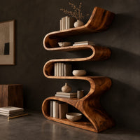 Corner detail of serpentine bookshelf made from one folding ribbon of wood with open curved shelves beside wood, brass and linen samples