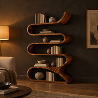 Serpentine bookshelf made from one folding ribbon of wood with open curved shelves in a dark living room at golden hour