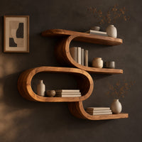 Corner detail of serpentine wall shelf with an open oval loop in the middle beside wood, brass and linen samples