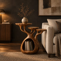 Tree form wood side table with three tops and a hollow base in a dark living room at golden hour