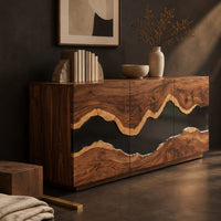 Corner detail of sideboard with three tall doors and a dark wavy band across the front beside wood, brass and linen samples