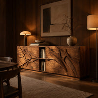 Low sideboard with carved branch doors and an open center bay in an evening dining room with walnut wall paneling