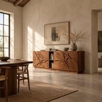 Low sideboard with carved branch doors and an open center bay in a bright open plan dining room