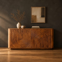 Sideboard with fluted arch carving and rounded ends in a dark studio against a charcoal plaster wall