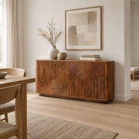 Sideboard with fluted arch carving and rounded ends in a Scandinavian dining room with white walls