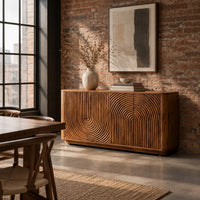 Sideboard with fluted arch carving and rounded ends in an industrial loft dining room with exposed brick
