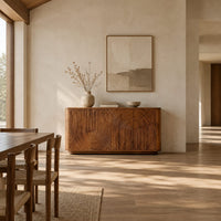 Sideboard with fluted arch carving and rounded ends in a bright open plan dining room
