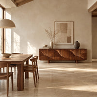 Sideboard on short block feet with flowing carved ridges across the front in a bright open plan dining room