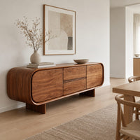 Long sideboard with soft oval ends and a four panel front in a Scandinavian dining room with white walls