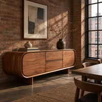 Long sideboard with soft oval ends and a four panel front in an industrial loft dining room with exposed brick