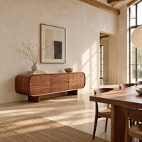 Long sideboard with soft oval ends and a four panel front in a bright open plan dining room