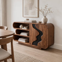 Sideboard with three stacked open shelves and a black wave inlay door in a Scandinavian dining room with white walls