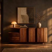 Sideboard with three grooved front panels and a lower block on one end in a dark dining room at golden hour