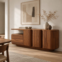 Sideboard with three grooved front panels and a lower block on one end in a Scandinavian dining room with white walls