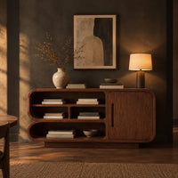 Sideboard with three tiers of open shelves beside a single slot pull door in a dark dining room at golden hour