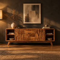 Sideboard with wave carved doors, three center drawers and open end shelves in a dark dining room at golden hour