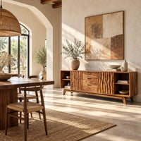 Sideboard with wave carved doors, three center drawers and open end shelves in a bright open plan dining room