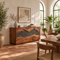 Boxy wooden sideboard with a wavy dark band across three front panels in a bright dining room with arched windows and plants