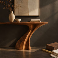 Corner detail of console table on a single sculpted pedestal that twists up to the top beside wood, brass and linen samples