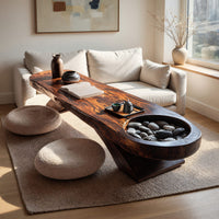 Long dark slab coffee table with a carved bowl in a bright modern living room