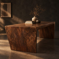 Rectangular slab dining table with tapered carved end panels, three-quarter view showing the grain