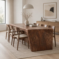 Rectangular slab dining table with tapered carved end panels in a Scandinavian dining room with white walls