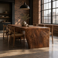Rectangular slab dining table with tapered carved end panels in an industrial loft dining room with exposed brick