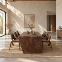 Rectangular slab dining table with tapered carved end panels in a bright open plan dining room