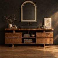 Slab top bathroom vanity with two drawer stacks and an open towel shelf in a dark studio against a charcoal plaster wall