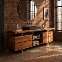 Slab top bathroom vanity with two drawer stacks and an open towel shelf in an industrial loft bathroom with exposed brick