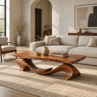 Slab top coffee table on a swooping wave shaped base in a bright open plan living room