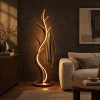 Slim floor lamp shaped like a branching tree with glowing lines in a dark living room at golden hour