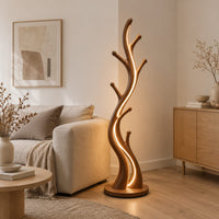 Slim floor lamp shaped like a branching tree with glowing lines in a Scandinavian living room with white walls