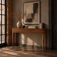 Slim console table with three front panels and tapered legs in an industrial loft entryway with exposed brick
